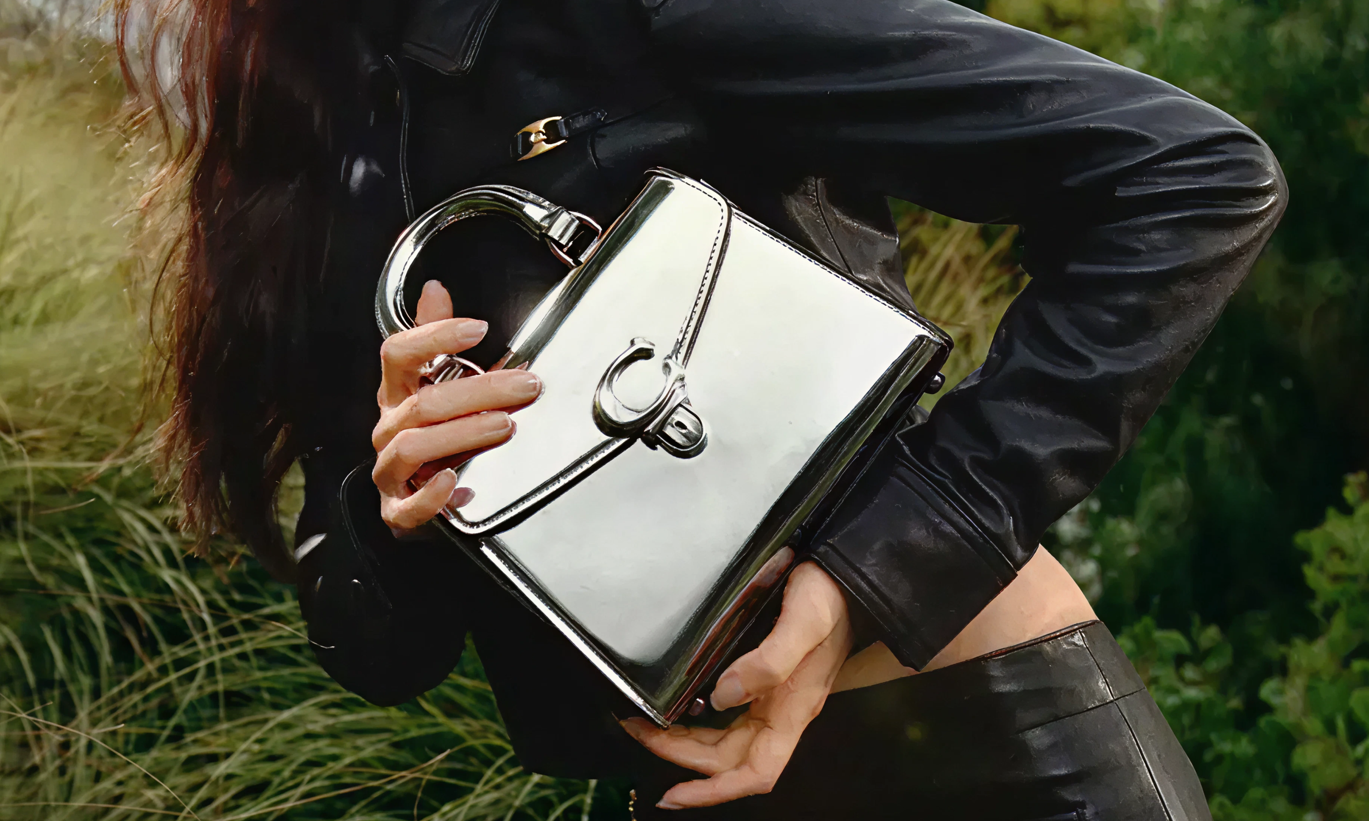 Coach cover photo - a woman holding a coach bag, smiling